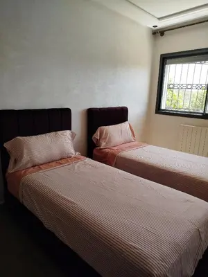 a bedroom with two beds and a window at Le Refuge de Vittel 2 in Ifrane