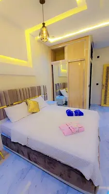 a bedroom with a large bed with two towels on it at Luxuriöse Wohnung in Fez in Fès