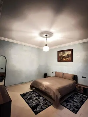 a bedroom with a bed and a ceiling at Intimate villa Private pool et Atlas view in Sidi Bouzguia