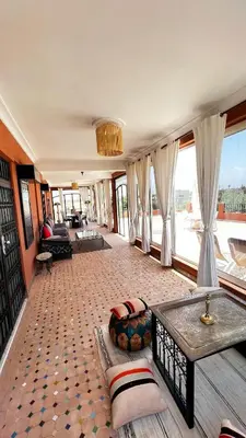 a living room with a couch and a table at Intimate villa Private pool et Atlas view in Sidi Bouzguia
