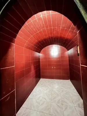 a red tiled hallway with a red brick wall at Intimate villa Private pool et Atlas view in Sidi Bouzguia