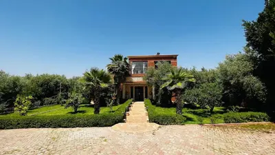 a house with a pathway leading to it with trees at Intimate villa Private pool et Atlas view in Sidi Bouzguia