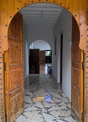 an archway leading into a room with a marble floor at Villa sans vis à vis Lina in Marrakech