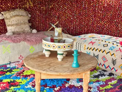 a table with a bowl with a candle in it at Villa sans vis à vis Lina in Marrakech