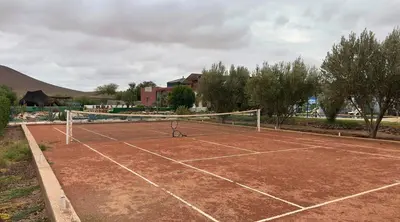 a tennis court with a tennis racket on it at Villa sans vis à vis Lina in Marrakech