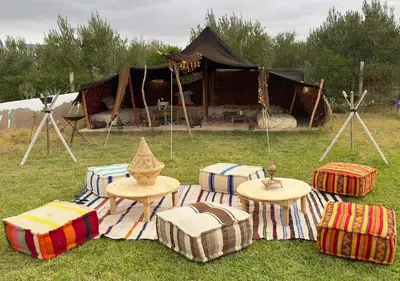 a group of tables and chairs in the grass with a tent at Villa sans vis à vis Lina in Marrakech