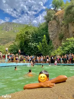 a group of people in the water at a swimming pool at دوار المروج بوعادل تاونات in Taounate