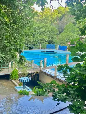 a swimming pool on a bridge over a river at دوار المروج بوعادل تاونات in Taounate