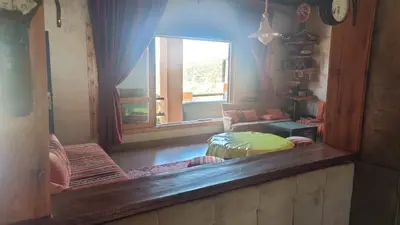 a mirror reflection of a living room with a window at Villa de reve in Bine el Ouidane