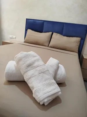 a bed with two towels on top of it at Le refuge de Vittel 3 in Ifrane