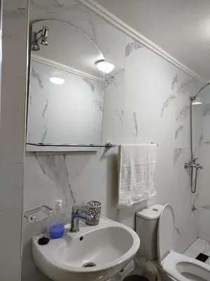 a white bathroom with a sink and a toilet at Le refuge de Vittel 3 in Ifrane