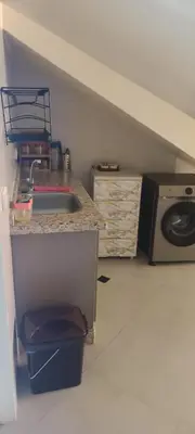 a kitchen with a sink and a microwave at Le refuge de Vittel in Ifrane