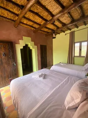 a bedroom with two beds in a room at Dar Imane - Magnifique ferme en pleine nature in Ouarzazate