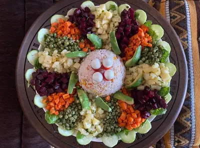 a plate of food with peas beans and vegetables at Dar Imane - Magnifique ferme en pleine nature in Ouarzazate