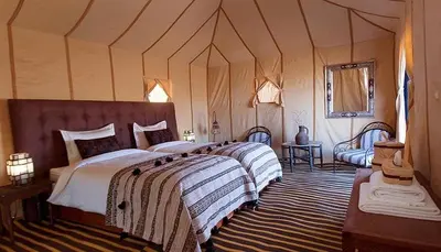 a bedroom with two beds in a tent at Starlight Mirage Camp in Lac Yasmins