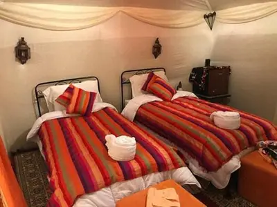 two beds sitting next to each other in a room at Starlight Mirage Camp in Lac Yasmins