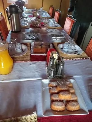 a long buffet line with a long table with pastries at Starlight Mirage Camp in Lac Yasmins