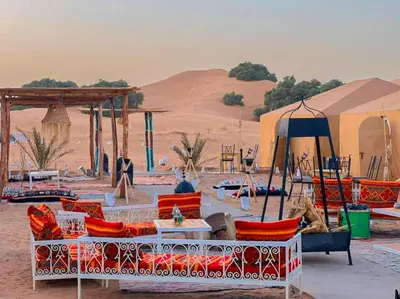 a group of chairs and tables in the desert at Starlight Mirage Camp in Lac Yasmins
