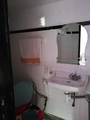 a bathroom with a sink and a mirror and a toilet at Chambre à deux lit in Fès