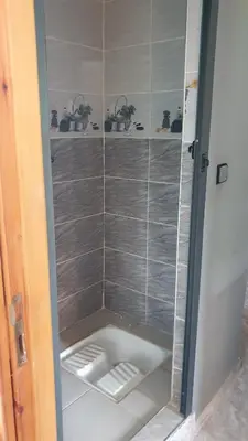 a walk in shower with a glass door at Bouadel taounate in Fès