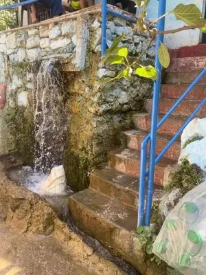 a stone staircase with a water fountain at Bouadel taounate in Fès