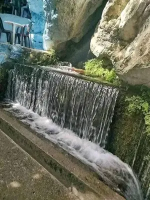 a waterfall on the side of a rock wall at Bouadel taounate in Fès
