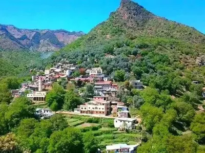 a village on a hill with a mountain at Bouadel taounate in Fès