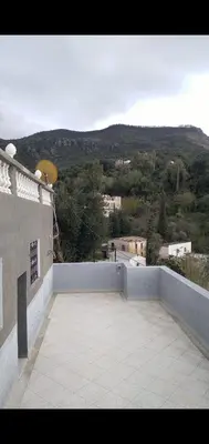 a balcony of a building with a view of a mountain at Bouadel taounate in Fès
