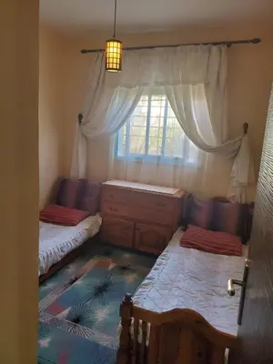a bedroom with two beds and a window at le bon coin in Ifrane