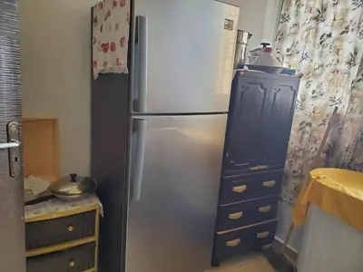 a kitchen with a stainless steel refrigerator and a dresser at le bon coin in Ifrane