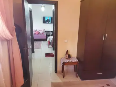 a hallway with a door open to a living room at le bon coin in Ifrane
