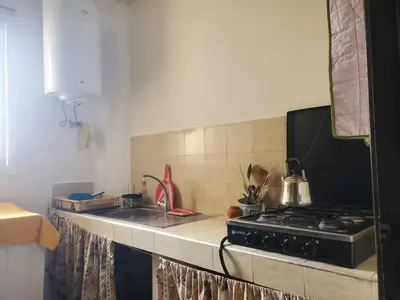 a kitchen counter with a stove and a sink at le bon coin in Ifrane