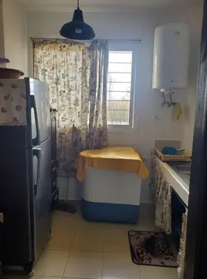 a kitchen with a refrigerator and a table in it at le bon coin in Ifrane
