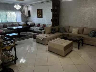 a large living room with couches and a table at Beautiful large apartment in Fès