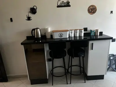 a kitchen with a counter with two bar stools at Beautiful large apartment in Fès