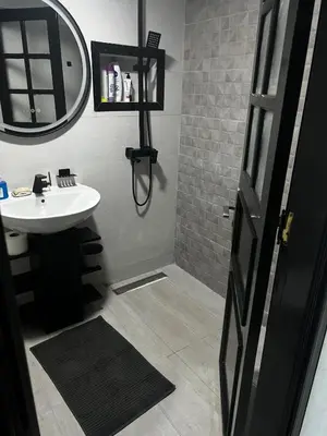 a bathroom with a sink and a mirror at Beautiful large apartment in Fès