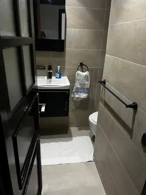 a bathroom with a sink and a toilet at Beautiful large apartment in Fès