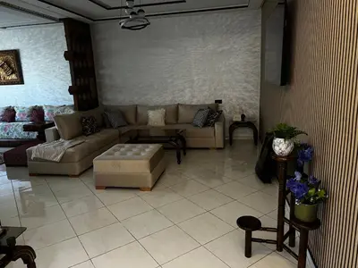 a living room with a couch and a table at Beautiful large apartment in Fès
