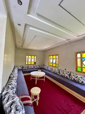 a living room with a large couch and a table at Villa Zine in Aït Namous