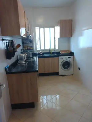 a kitchen with a sink and a washing machine at Apartment Rabat Agdal in Oulad Akkou