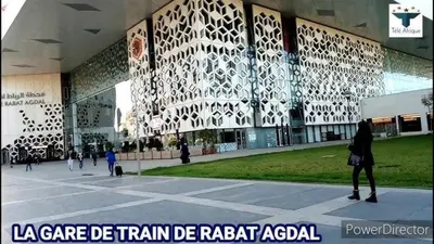 a woman walking in front of a building at Apartment Rabat Agdal in Oulad Akkou