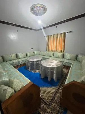 a living room with a couch and a table at desert appartement in Merzouga