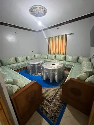a living room with a couch and a table at desert appartement in Merzouga