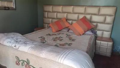 a bed with two pillows on top of it at Villa de rêve in Bine el Ouidane