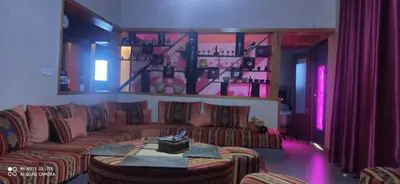 a living room with a couch and a table at Villa de rêve in Bine el Ouidane