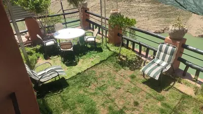 a balcony with chairs and a table and a table and chairs at Villa de rêve in Bine el Ouidane