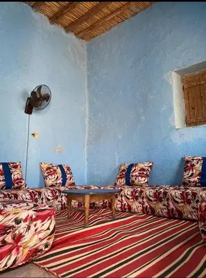 a living room with a couch and a table at Housse stander merzouga in Merzouga