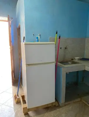 a kitchen being remodeled with a sink and a refrigerator at Housse stander merzouga in Merzouga