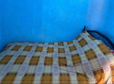 a blue bedroom with a bed with a blue wall at Housse stander merzouga in Merzouga