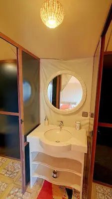 a bathroom with a sink and a mirror at Arabian Nights Desert Camp Merzouga in Lac Yasmins